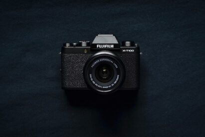 Flatly of compact FujiFilm brand point-and-shoot camera on a black background