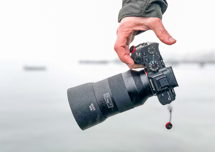 Hand holding a Sony mirrorless camera 