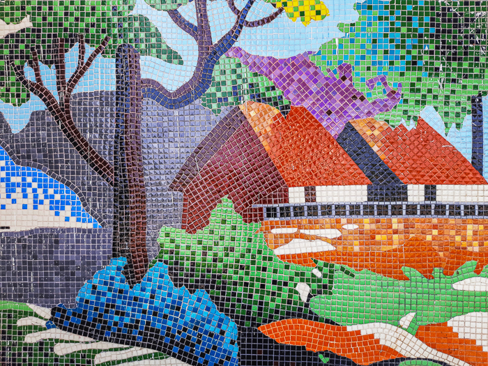 A colorful tiled mosaic of house and landscape