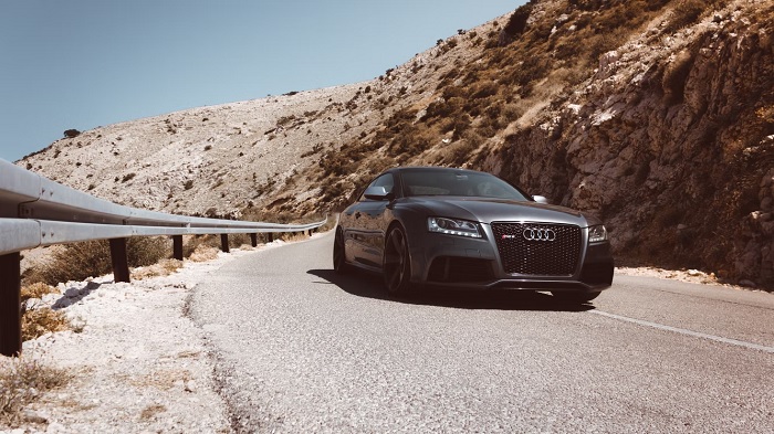 Car going round the corner of a mountain road