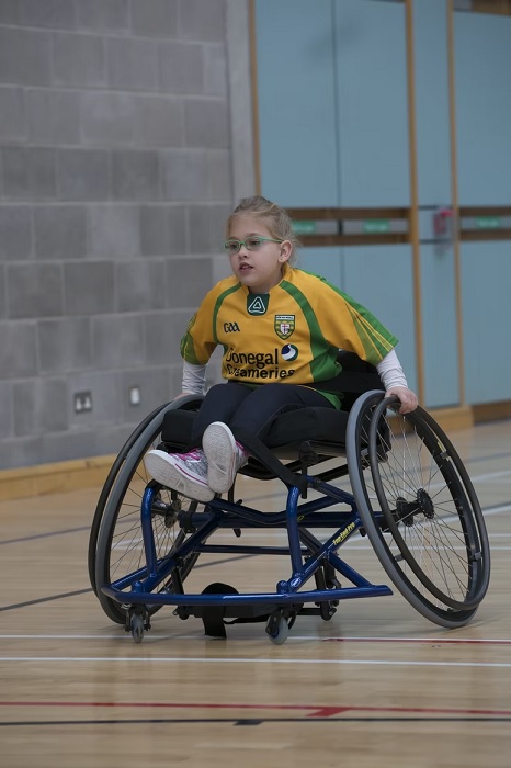 Girl in a wheelchair playing sports
