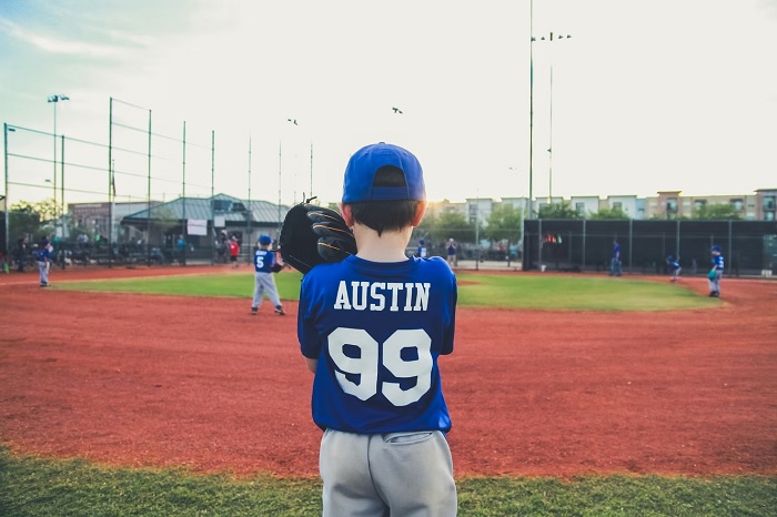 Young baseball player facing away from camera