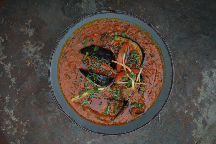 A food photography photo of a Thai soup dish