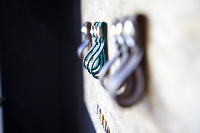 Leather hoops hanging on a row on the wall shot with a shallow depth of field
