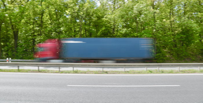 Blurred lorry on road