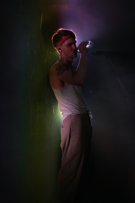 A backlit photo of a singer on stage