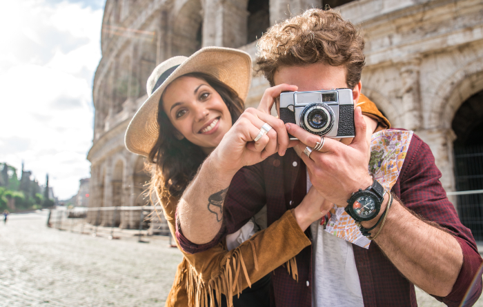 Couple of amateur photographers outside the Colosseum taking a photo