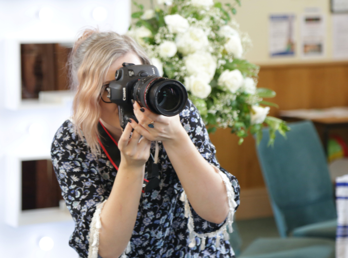 Photographer at a wedding with a Canon camera
