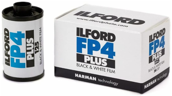 Product photo of Ilford FP4 film canister beside its packaging 
