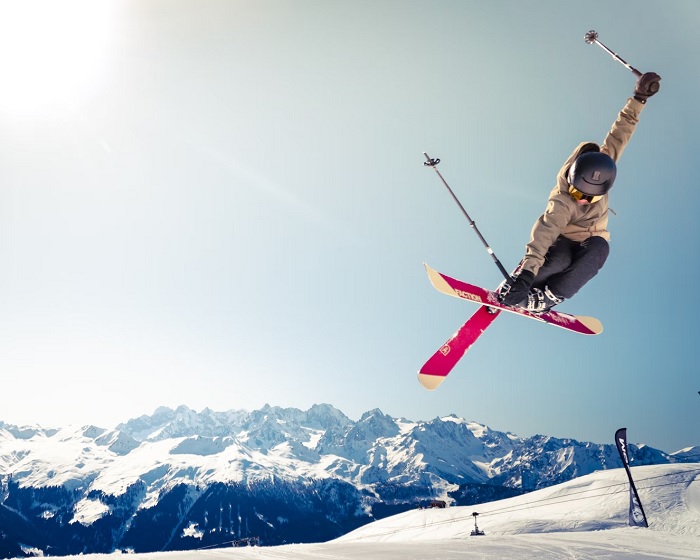 Skier doing a trick in mid-air on a snowy mountain