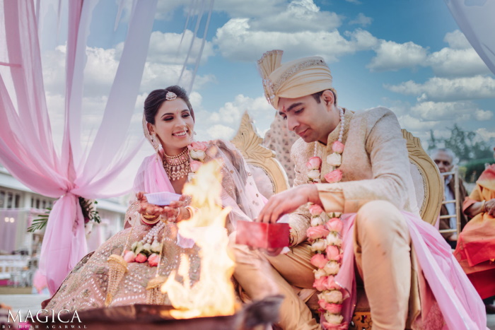 Beautiful wedding portrait of a couple at an Indian wedding by a fire