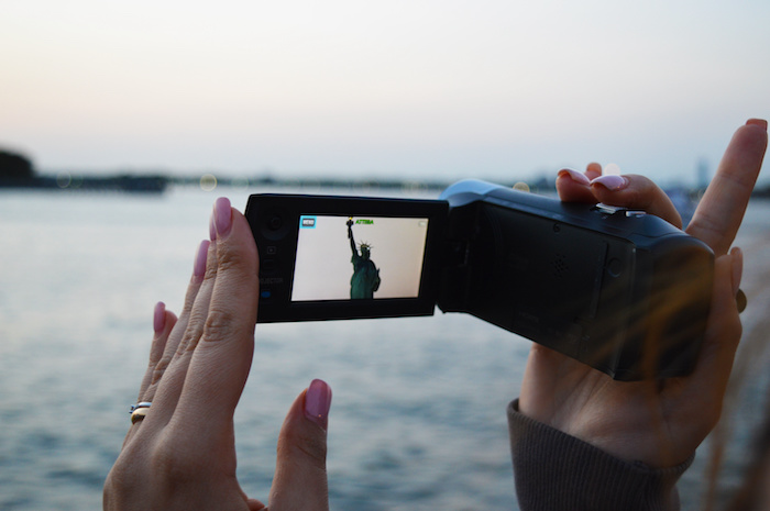 Camcorder zooming in on the Statue of Liberty