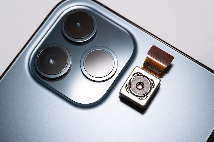Digital camera sensor of a smartphone beside it's camera lenses