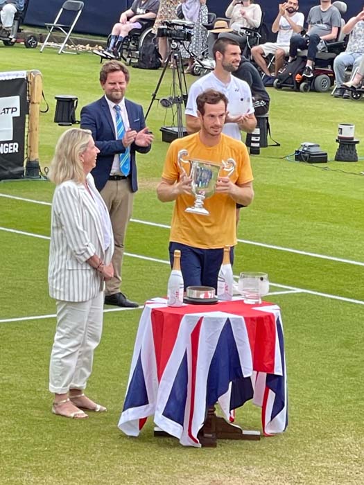 Tennis player Andy Murray receiving a trophy at a tournament