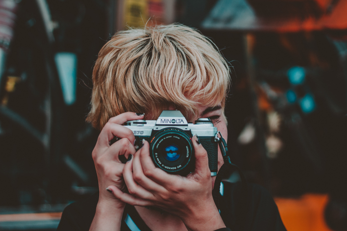  a female photographer shooting with a minolta camera 