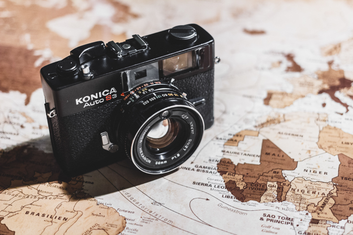  finding camera manuals online: a konica camera sits on top of a world map