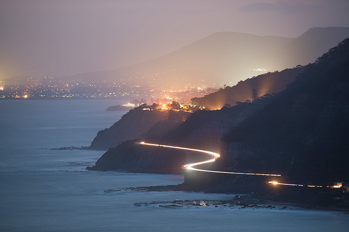 A fog photograph of a coastal road in evening