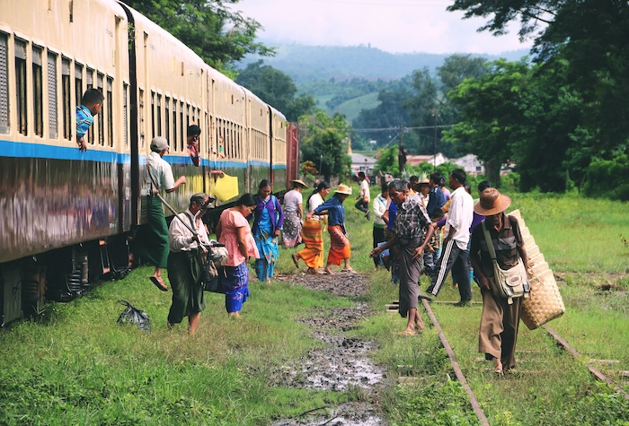 People exiting a train in a rural area